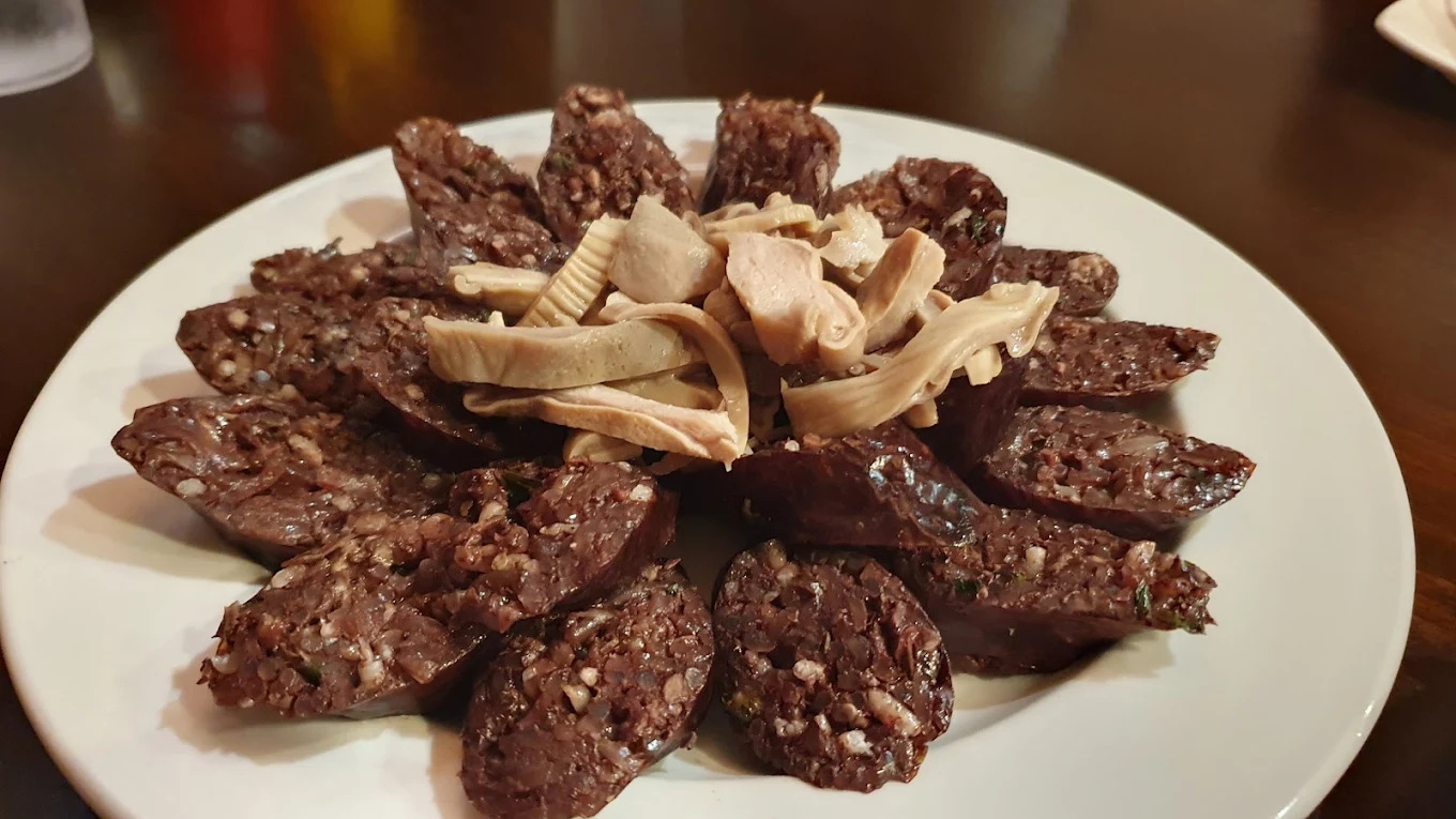 Sliced Korean sundae blood sausage arranged in a ring on a white plate